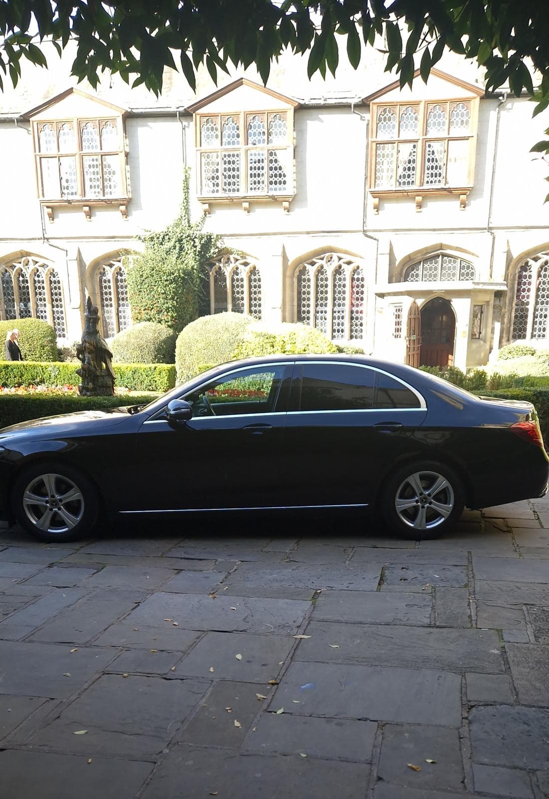 Black executive saloon outside a hotel