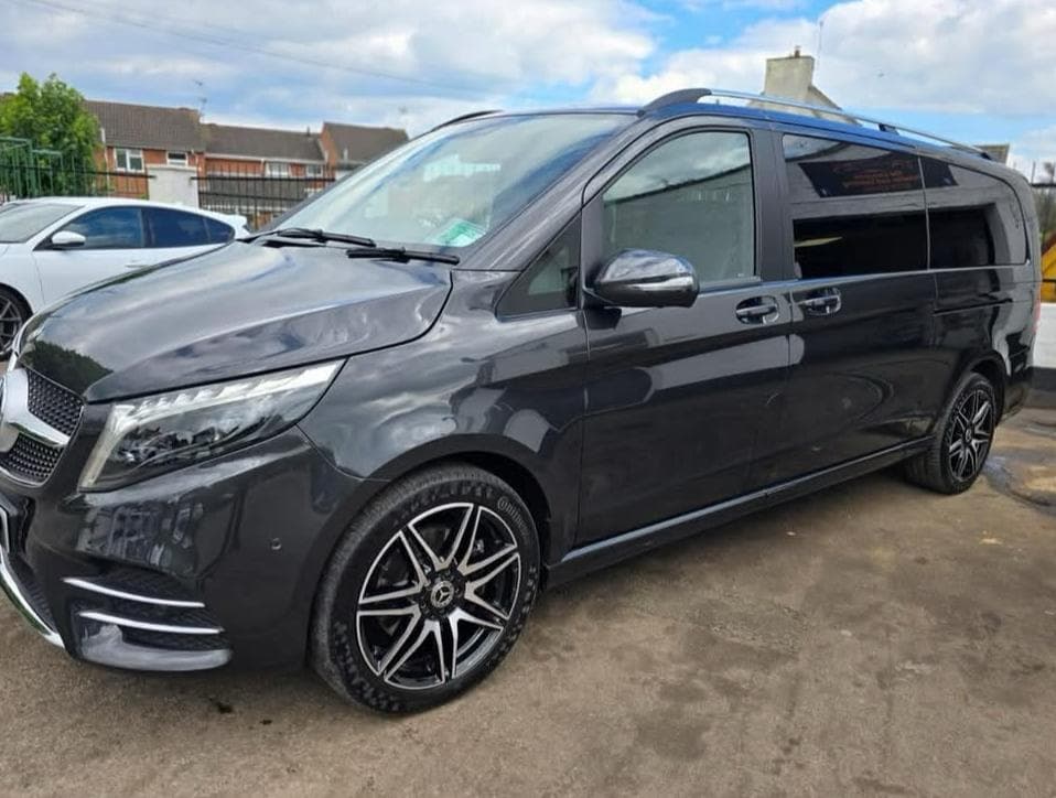 Black minibus viewed from the front
