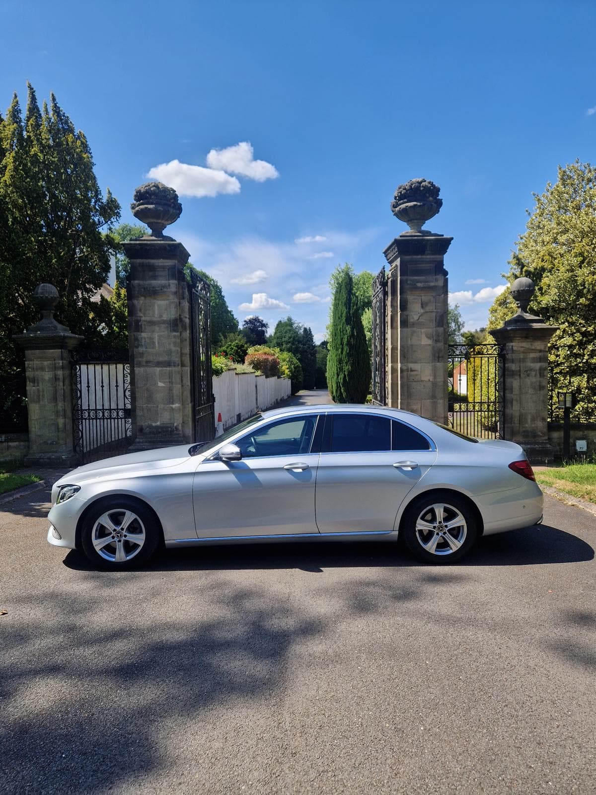 Silver executive saloon at a country estate entrance