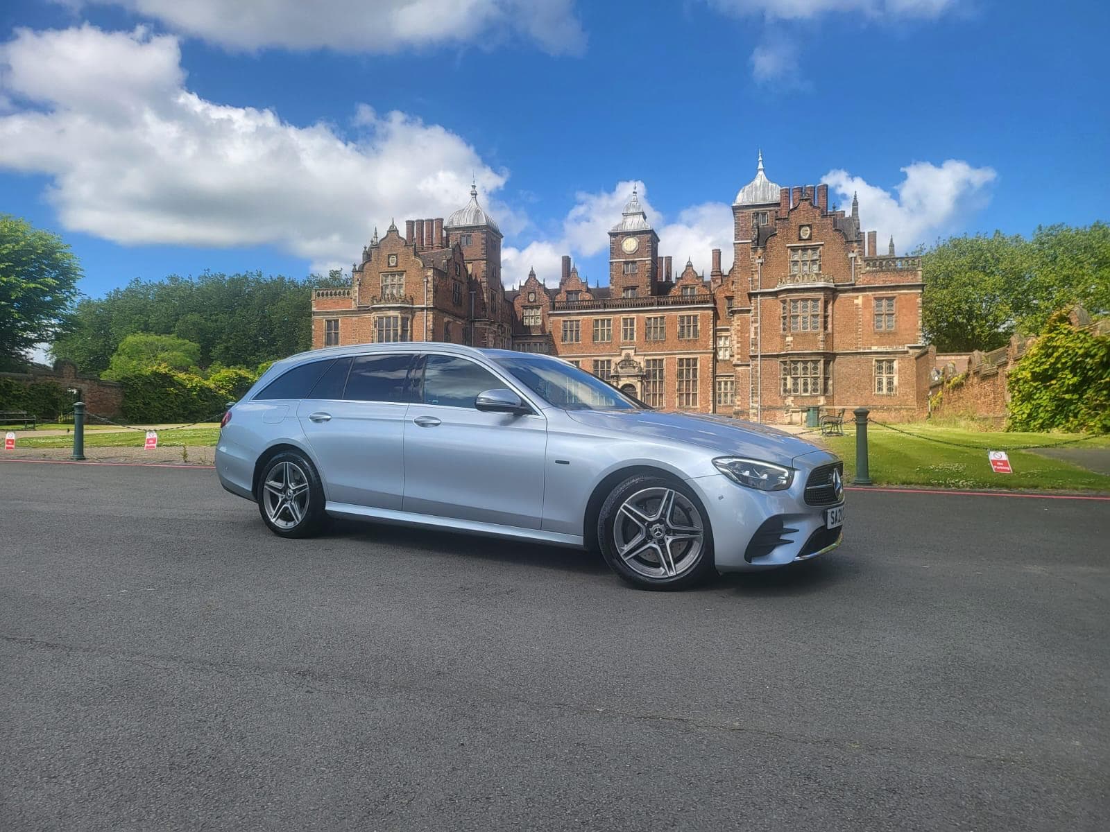 Silver Mercedes saloon outside a country house