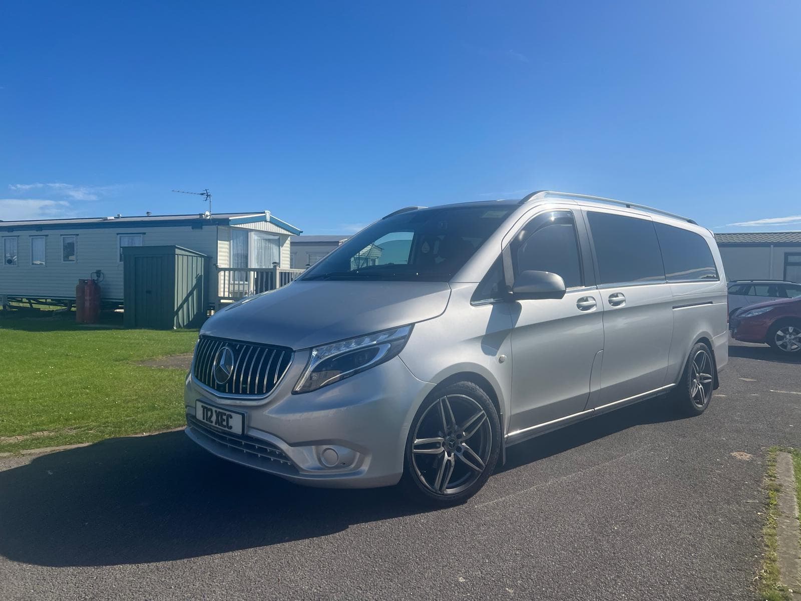 Silver Mercedes minibus on a sunny day
